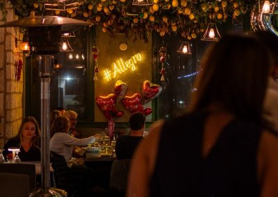 heart balloons at the end of allegro's dining tables with lemons hanging from the ceiling and allegro's neon sign